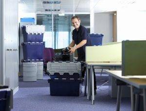 movers packing Stevens crates in office